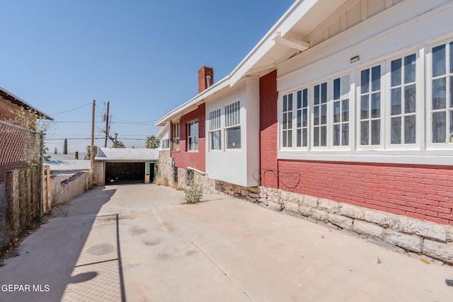2712 Federal Ave, El Paso, TX 79930 - view of property exterior featuring a chimney, brick siding, and driveway