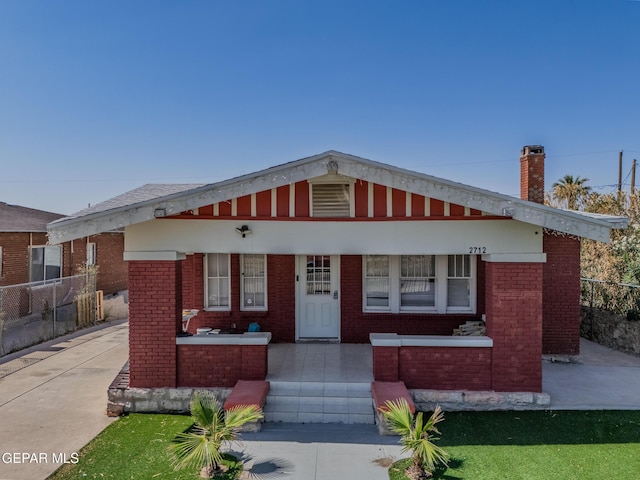 2712 Federal Ave, El Paso, TX 79930 - bungalow featuring brick siding, a chimney, and covered porch
