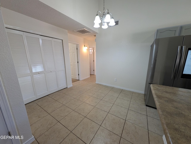 11740 Autumn Wheat Dr, El Paso, TX 79934 - unfurnished dining area with a chandelier, light tile patterned floors, and baseboards