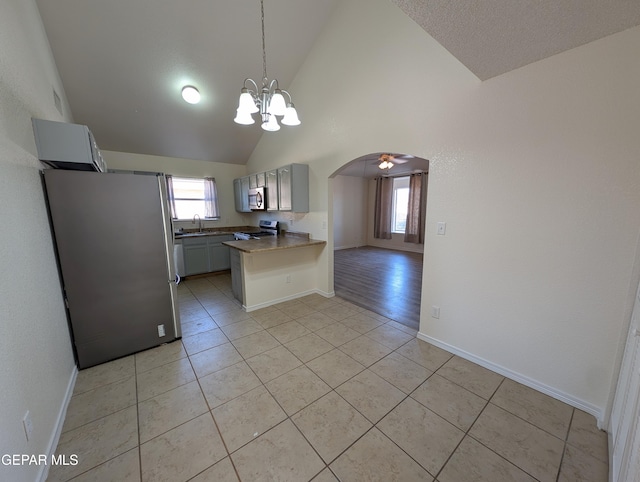 11740 Autumn Wheat Dr, El Paso, TX 79934 - kitchen with appliances with stainless steel finishes, a sink, a peninsula, healthy amount of natural light, and high vaulted ceiling