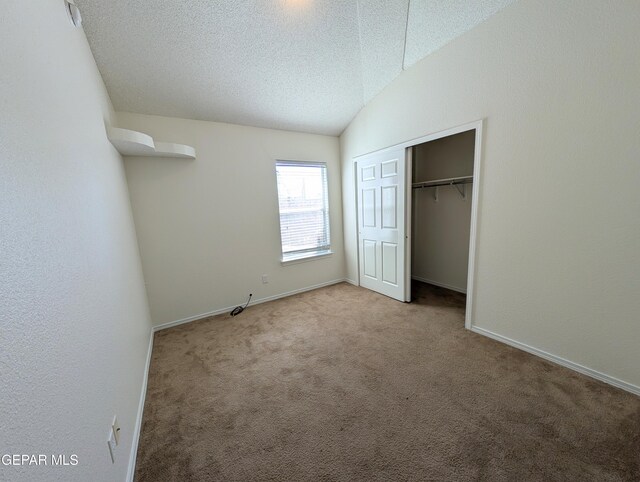 11740 Autumn Wheat Dr, El Paso, TX 79934 - unfurnished bedroom featuring carpet floors, a textured ceiling, baseboards, vaulted ceiling, and a closet