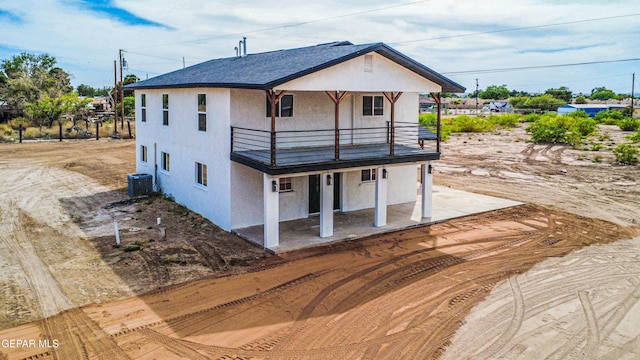 13090 Socorro Rd, San Elizario, TX 79849 - rear view of property with a balcony, central AC unit, and stucco siding