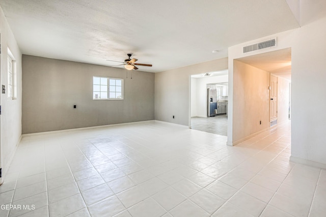 13090 Socorro Rd, San Elizario, TX 79849 - unfurnished room featuring a ceiling fan, light tile patterned flooring, and baseboards