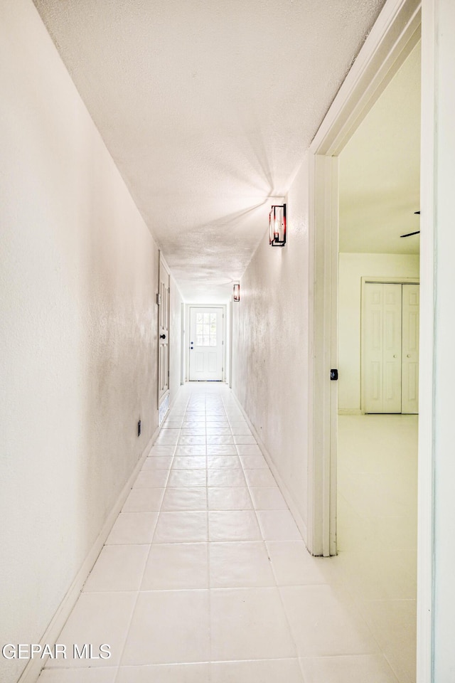 13090 Socorro Rd, San Elizario, TX 79849 - corridor with light tile patterned flooring and a textured ceiling