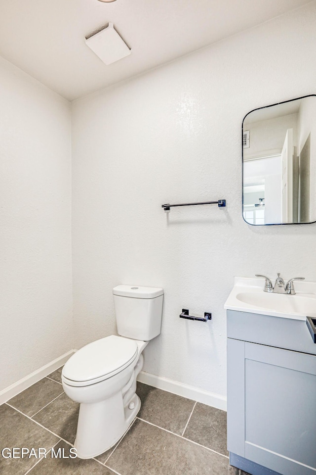 13090 Socorro Rd, San Elizario, TX 79849 - half bath featuring vanity, toilet, tile patterned flooring, and baseboards