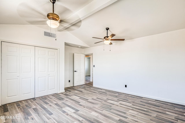 13090 Socorro Rd, San Elizario, TX 79849 - unfurnished bedroom featuring wood finished floors, vaulted ceiling, a closet, baseboards, and a ceiling fan