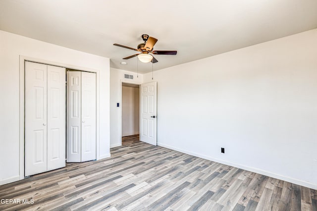13090 Socorro Rd, San Elizario, TX 79849 - unfurnished bedroom with light wood finished floors, a closet, baseboards, and a ceiling fan