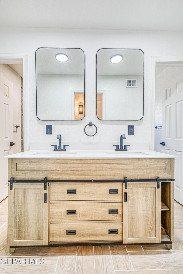 13090 Socorro Rd, San Elizario, TX 79849 - full bathroom with double vanity and wood finished floors