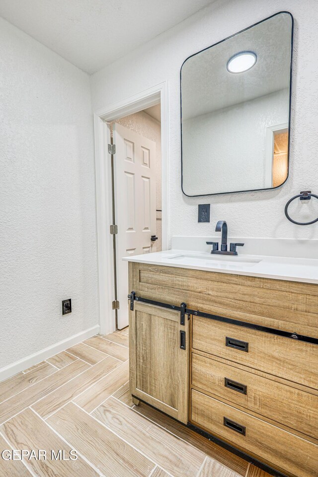13090 Socorro Rd, San Elizario, TX 79849 - bathroom with vanity, baseboards, and parquet floors