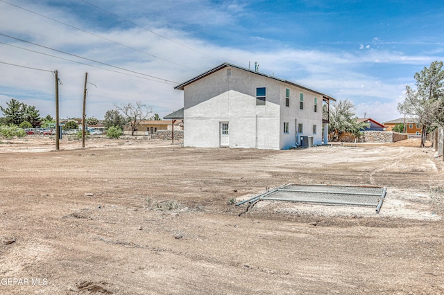 13090 Socorro Rd, San Elizario, TX 79849 - back of property with stucco siding and central AC unit