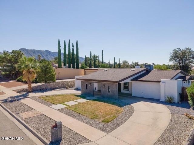 6504 Camino Fuente Dr, El Paso, TX 79912 - view of front of house with a mountain view, curved driveway, and roof with shingles