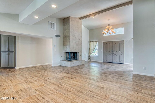6504 Camino Fuente Dr, El Paso, TX 79912 - unfurnished living room with high vaulted ceiling, a chandelier, beamed ceiling, baseboards, and light wood-style floors