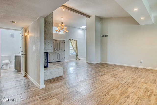 6504 Camino Fuente Dr, El Paso, TX 79912 - foyer entrance with a chandelier, baseboards, wood finished floors, beam ceiling, and high vaulted ceiling