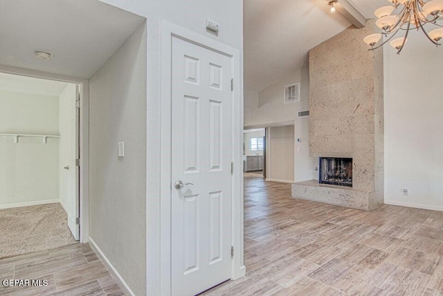 6504 Camino Fuente Dr, El Paso, TX 79912 - hall featuring a chandelier, light wood-style floors, and baseboards