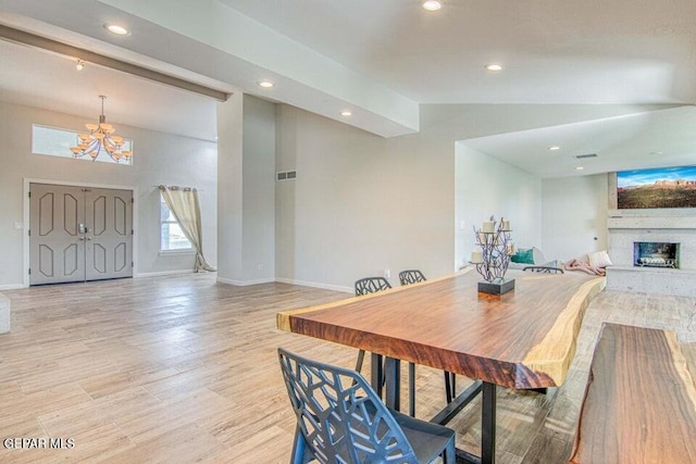 6504 Camino Fuente Dr, El Paso, TX 79912 - dining space featuring a chandelier, baseboards, recessed lighting, a fireplace with raised hearth, and light wood-type flooring