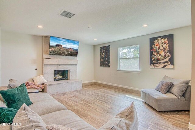 6504 Camino Fuente Dr, El Paso, TX 79912 - living room with wood finished floors, recessed lighting, a large fireplace, and baseboards