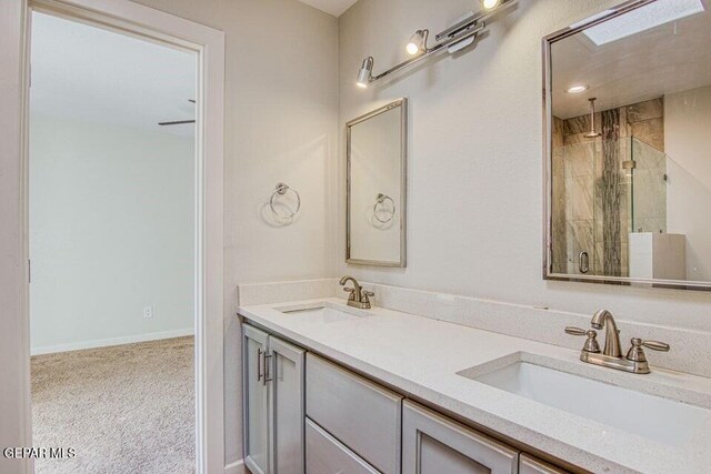 6504 Camino Fuente Dr, El Paso, TX 79912 - full bathroom with a stall shower, double vanity, and baseboards