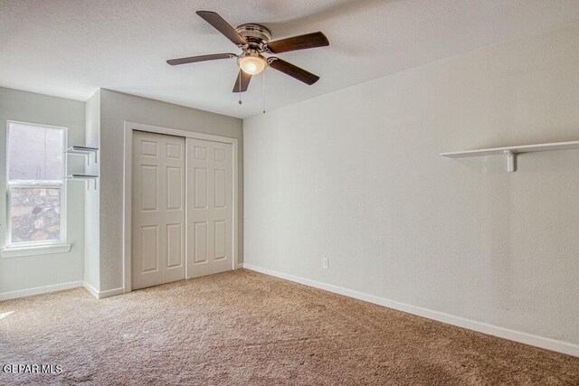 6504 Camino Fuente Dr, El Paso, TX 79912 - unfurnished bedroom featuring carpet flooring, a closet, baseboards, and ceiling fan
