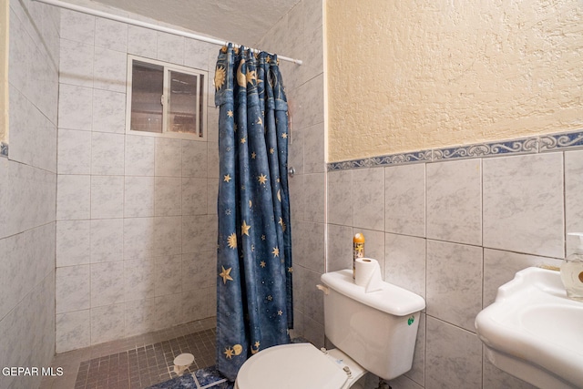 363 Ontiveros St, El Paso, TX 79932 - bathroom with toilet, a stall shower, and tile walls