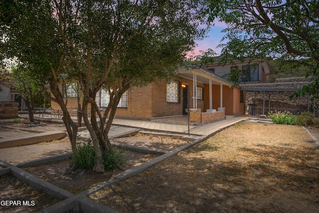 1611 N Kansas St, El Paso, TX 79902 - view of home's exterior featuring brick siding and a porch