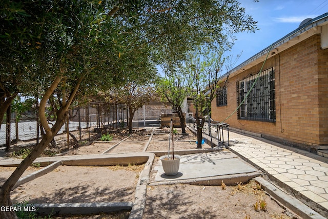 1611 N Kansas St, El Paso, TX 79902 - fenced backyard featuring a vegetable garden