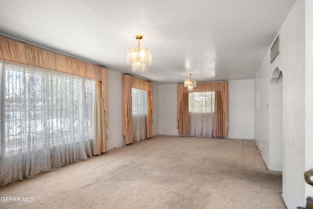1611 N Kansas St, El Paso, TX 79902 - spare room featuring a chandelier and light carpet