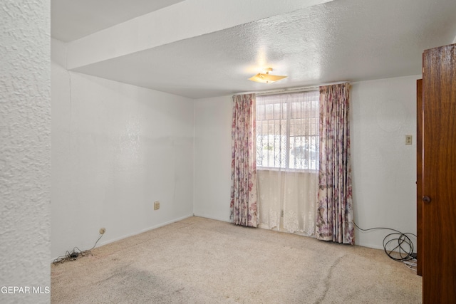 1611 N Kansas St, El Paso, TX 79902 - spare room with carpet floors and a textured ceiling