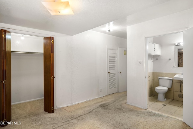 1611 N Kansas St, El Paso, TX 79902 - carpeted bedroom with ensuite bath and a closet