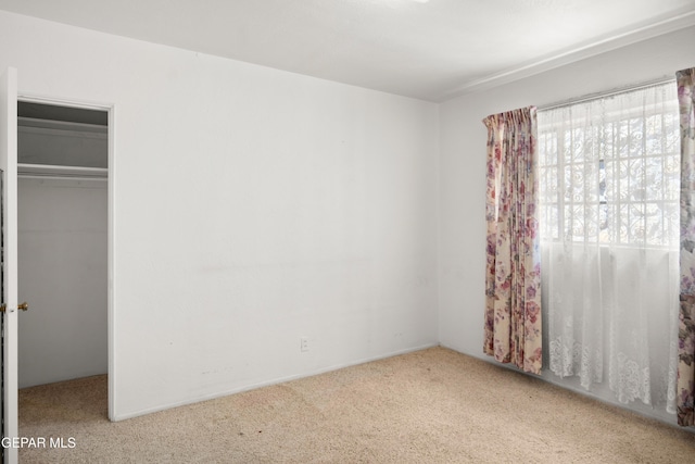 1611 N Kansas St, El Paso, TX 79902 - unfurnished bedroom with carpet floors, a closet, and a walk in closet