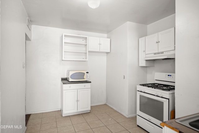 1611 N Kansas St, El Paso, TX 79902 - kitchen featuring white appliances, under cabinet range hood, white cabinetry, baseboards, and light tile patterned floors