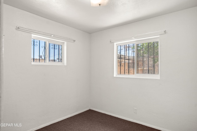 1611 N Kansas St, El Paso, TX 79902 - spare room with dark colored carpet and baseboards