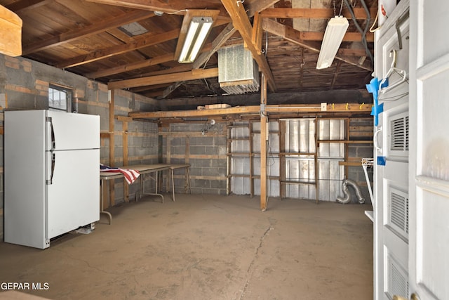 1611 N Kansas St, El Paso, TX 79902 - garage featuring freestanding refrigerator and concrete block wall