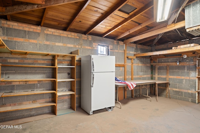 1611 N Kansas St, El Paso, TX 79902 - basement with freestanding refrigerator and concrete block wall