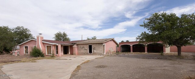 6100 Valley Dr, El Paso, TX 79932 - view of front of property with a detached carport, a chimney, and driveway