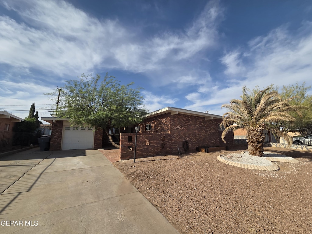 5121 Juliandra Ave, El Paso, TX 79924 - view of front of house with brick siding, driveway, and a garage