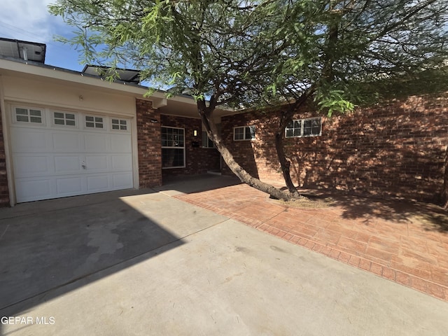 5121 Juliandra Ave, El Paso, TX 79924 - ranch-style house featuring concrete driveway, brick siding, and a garage