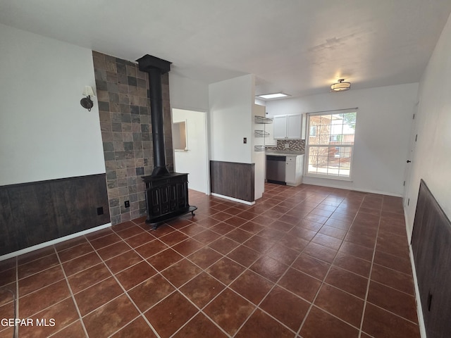 5121 Juliandra Ave, El Paso, TX 79924 - unfurnished living room featuring dark tile patterned flooring and a wood stove