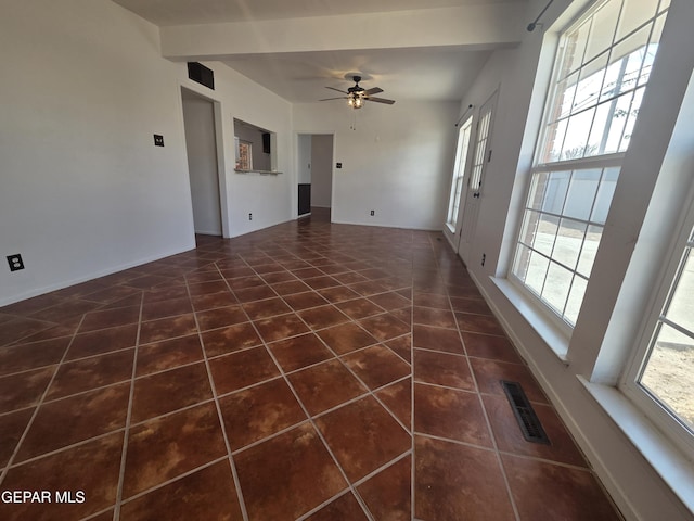 5121 Juliandra Ave, El Paso, TX 79924 - unfurnished living room featuring tile patterned flooring, a ceiling fan, healthy amount of natural light, and baseboards