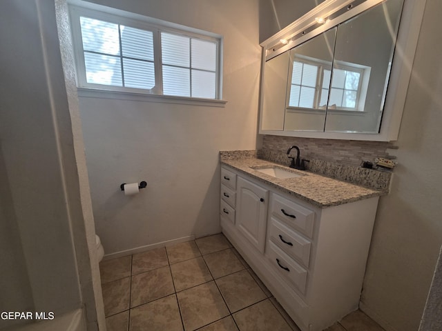 5121 Juliandra Ave, El Paso, TX 79924 - bathroom featuring vanity, toilet, tile patterned flooring, baseboards, and decorative backsplash
