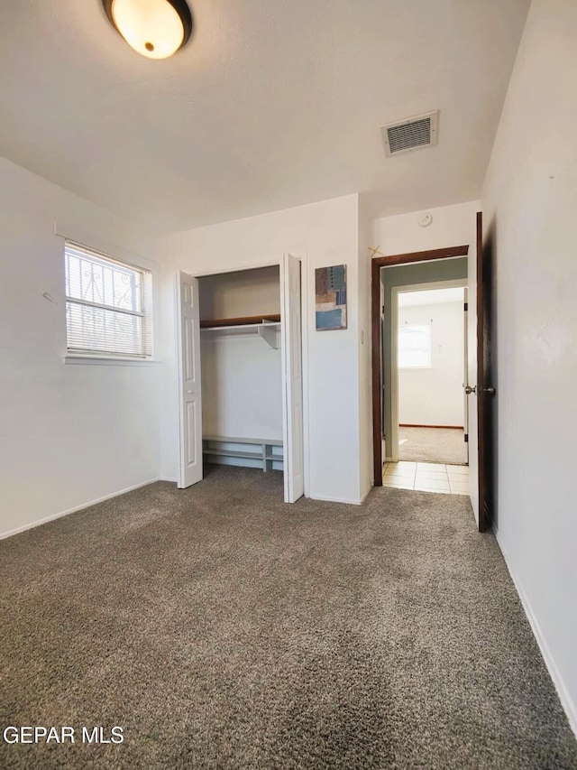 10077 Kirwood St, El Paso, TX 79924 - unfurnished bedroom with multiple windows, carpet floors, a closet, and baseboards