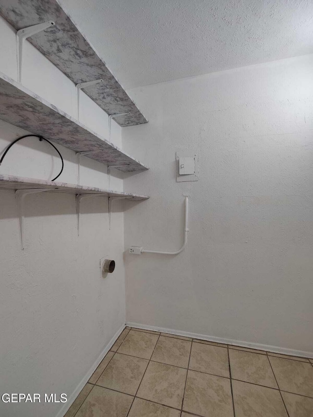 10077 Kirwood St, El Paso, TX 79924 - washroom featuring baseboards and light tile patterned flooring