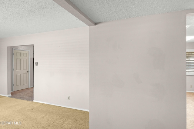 8213 Mineola Dr, El Paso, TX 79925 - empty room with light carpet, baseboards, and a textured ceiling