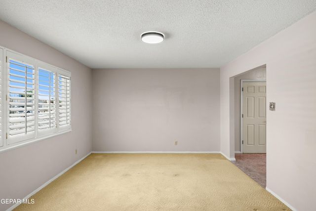 8213 Mineola Dr, El Paso, TX 79925 - carpeted empty room with baseboards and a textured ceiling