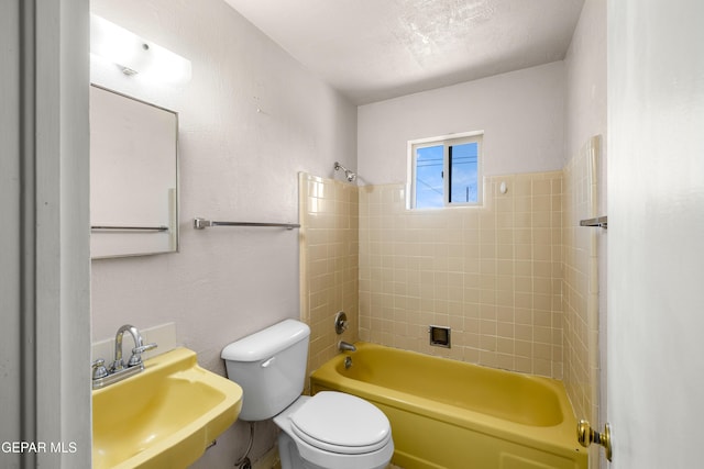 8213 Mineola Dr, El Paso, TX 79925 - bathroom featuring a sink, toilet, and tub / shower combination