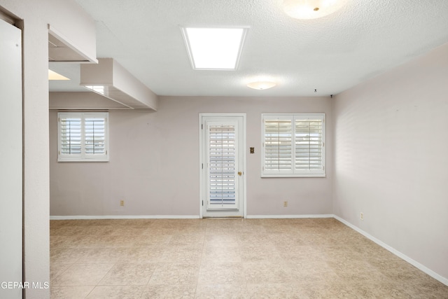 8213 Mineola Dr, El Paso, TX 79925 - spare room featuring baseboards and a textured ceiling
