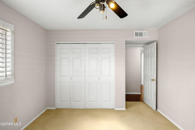 8213 Mineola Dr, El Paso, TX 79925 - unfurnished bedroom featuring light carpet, multiple windows, a closet, and baseboards