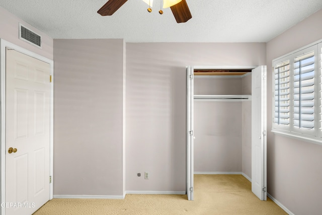8213 Mineola Dr, El Paso, TX 79925 - unfurnished bedroom with light colored carpet, a closet, baseboards, ceiling fan, and a textured ceiling