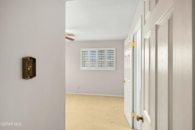 8213 Mineola Dr, El Paso, TX 79925 - corridor with carpet, baseboards, and a textured ceiling