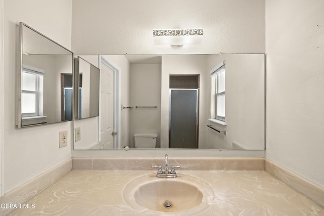 8213 Mineola Dr, El Paso, TX 79925 - bathroom with toilet, vanity, and plenty of natural light