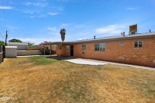 8213 Mineola Dr, El Paso, TX 79925 - back of property featuring brick siding, a patio area, and crawl space